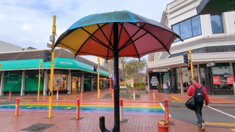 colorful umbrella art installation on a rainbow crosswalk