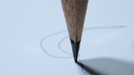 drawing lines on paper with pencil closeup