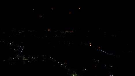 Aerial-flight-through-dark-night-sky-with-floating-lanterns-in-Thailand