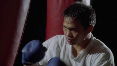 a boxer practices on a punching bag