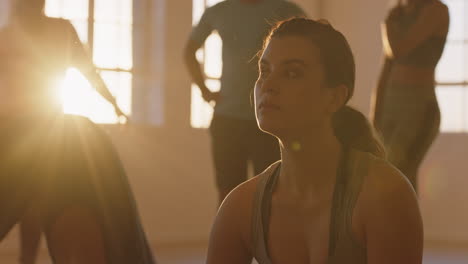 yoga class beautiful woman ready for early morning fitness workout relaxing on exercise mat in studio at sunrise