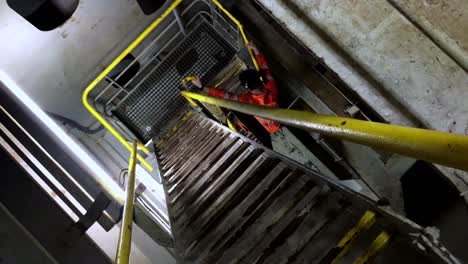 engineer in high-vis safety clothing walking down ladder inside boat