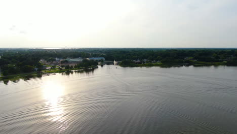 Evening-Flight-over-Lake-Ocoee-in-Central-Florida-featuring-boats,-a-fountain-and-an-early-sunset