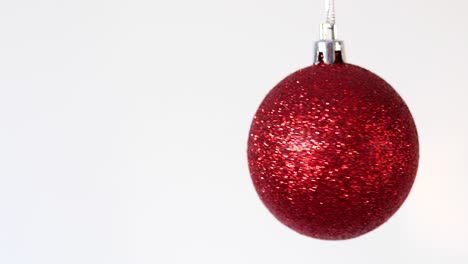 christmas. christmas red toy swinging on a white background