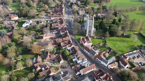 a drone flight over dedham on the essex-suffolk border panning from the left to the village and church on the right with views of the whole village and surrounding countryside