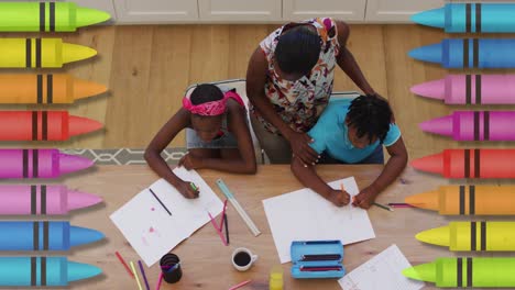 Multiple-colored-pencils-against-african-american-mother-helping-her-son-with-his-homework