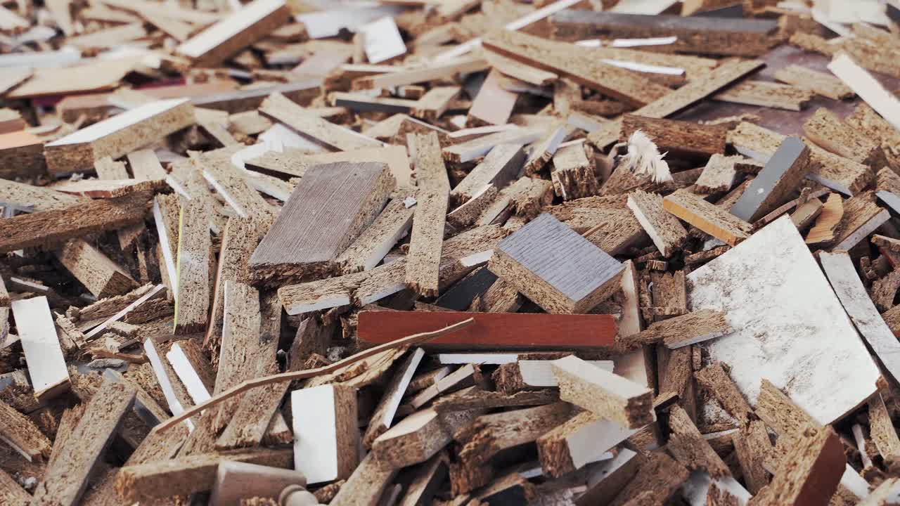 Garbage dump of furniture production waste. Chipboard wood scraps. A pile of rubbish. Close-up