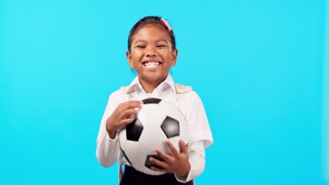 Girl-child,-football-and-studio-for-smile-on-face