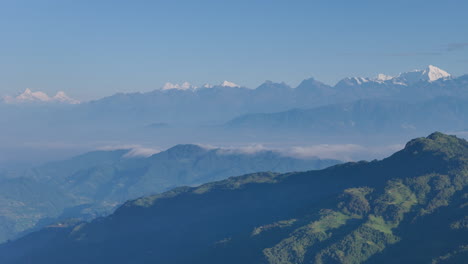 panning drone shot capturing vibrant green hills, dense forests stunning mountain landscapes of dolakha sailung, nepal near tibet mountain ranges, shows sunrays greenery region's eco-friendly tourism