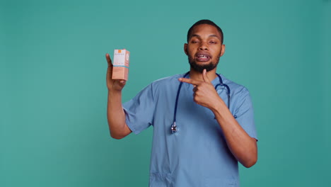 Portrait-of-nurse-holding-spf50-sunscreen-product