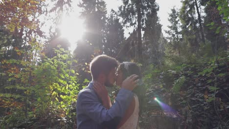 Groom-with-bride-near-mountain-hills-in-the-forest.-Wedding-couple.-Sunbeams