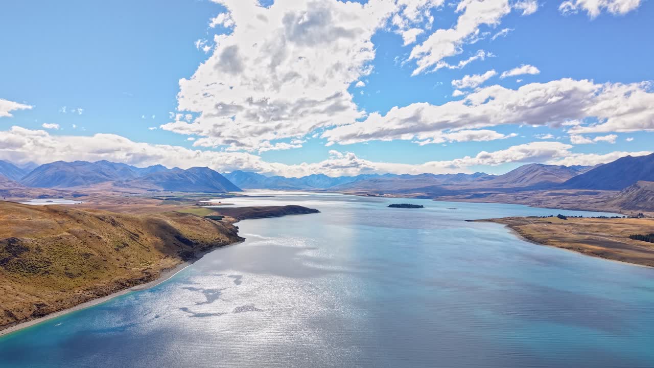 Stunning aerial view of Lake Tekapo's blue water under a bright sky