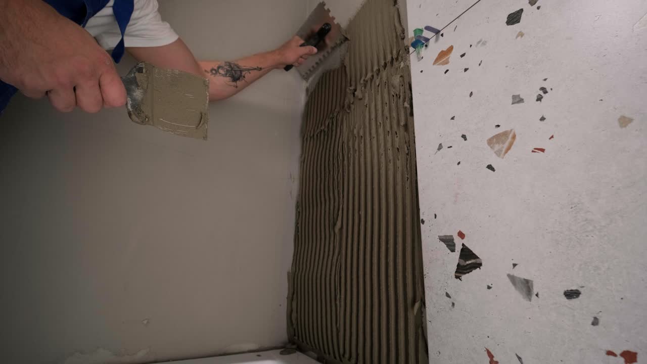 Installing ceramic wall tiles - measuring and cutting the pieces. Construction, renovation, repair apartment. Cuts tile. Tile cutting