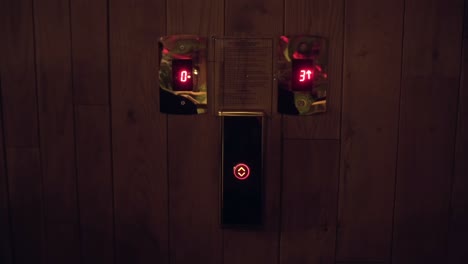 businessman in a suit pressing the elevator button and waiting for the lift to come