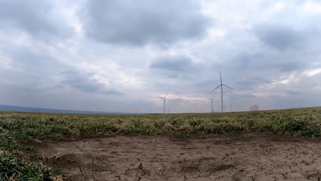 wide angle view of wind turbines at the wind farm under dramatic sky