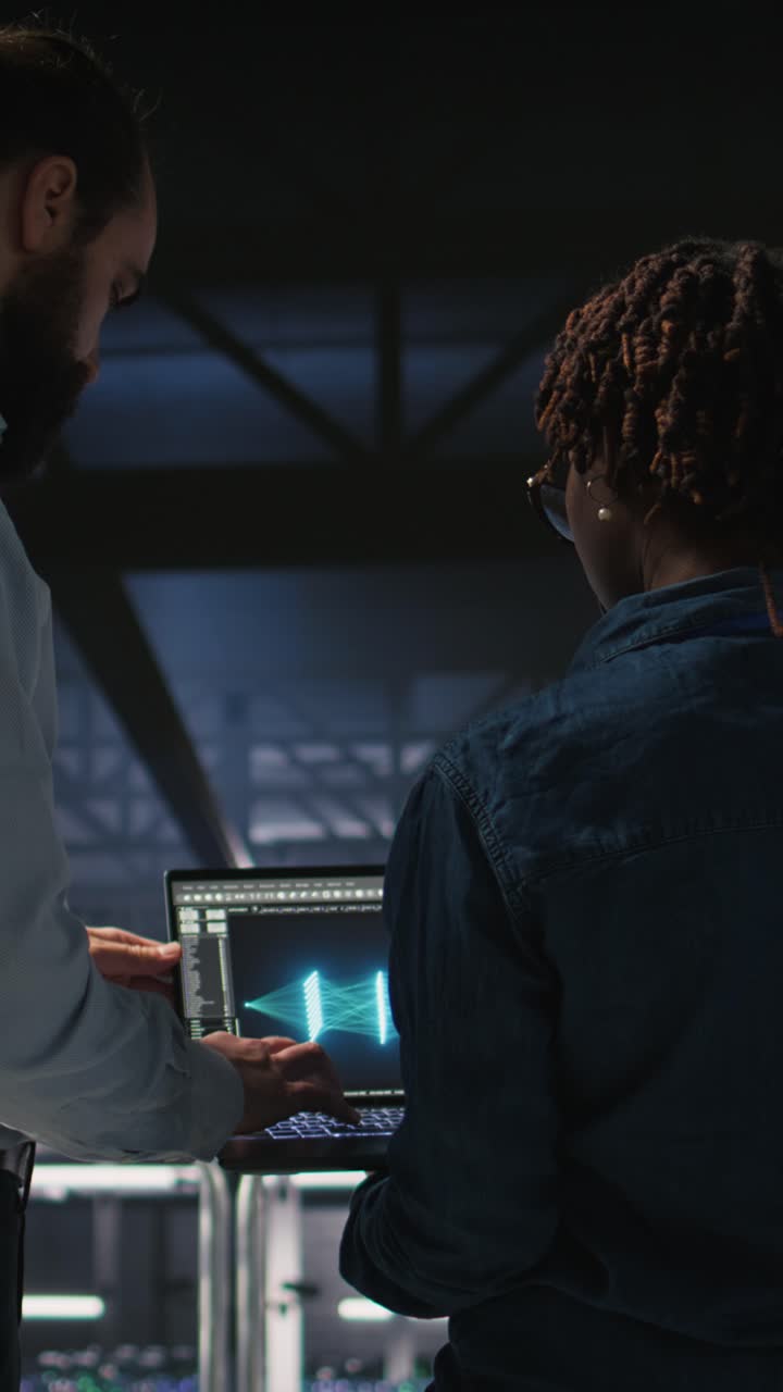 Vertical video Server farm manager overseeing work done by engineer reviewing LLM visualization