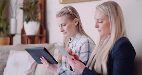 businesswomen discussing over technologies in office businesswomen working on digital tablet 1