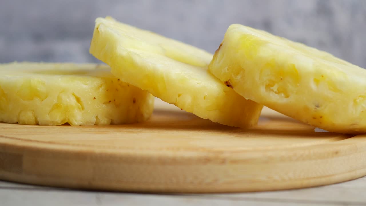 Fresh Pineapple Slices on a Wooden Cutting Board