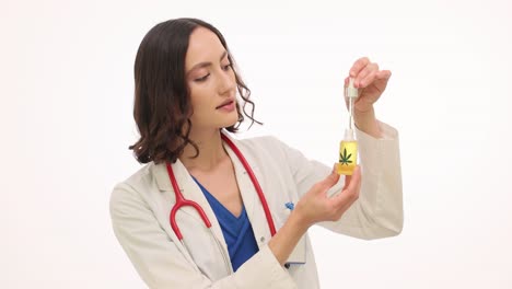 female doctor examining cbd oil dropper bottle