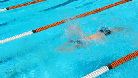 male swimmer swimming inside pool 4k