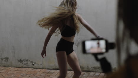 dancing woman young caucasian freestyle dancer performing for friend using smartphone taking video enjoying sharing hip hop dance on social media