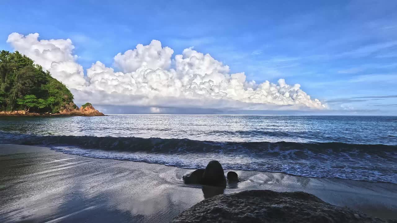 Ambient motion of waves lapping at the shore in a calm and soothing beach scene in Krabi, Thailand