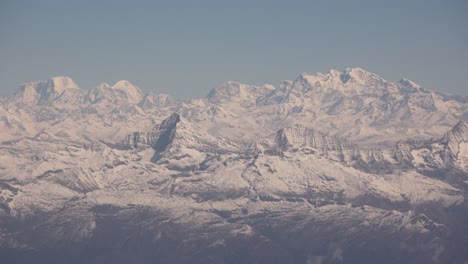 scenic aerial flight over the worlds largest mountains, the himalayas with views of mount everest and jagged snowcapped peaks