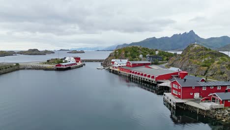 lofoten islands fishing factory and red cabins in mortsund, norway - aerial 4k