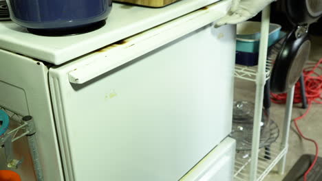 Home-baker-is-putting-a-tray-of-cupcakes-into-the-old-oven-for-baking