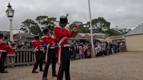 soldiers in red coats performing for an audience