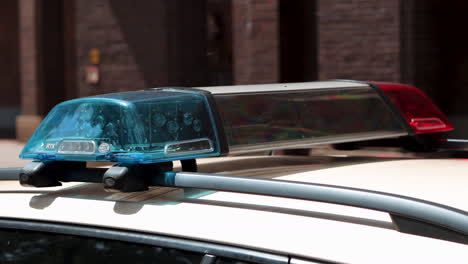 close up of flashing blue and red lights on police car