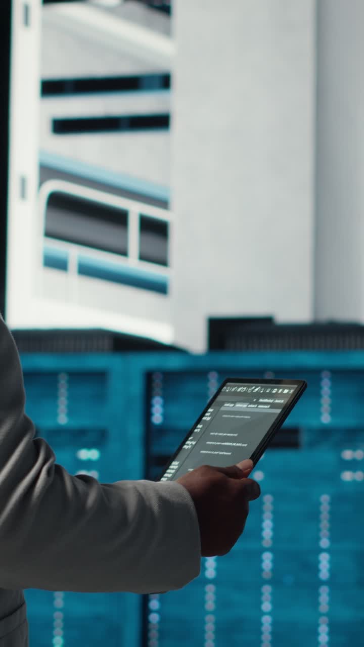 Vertical video Data center technician using laptop to manage software updates