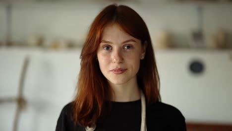 a red-haired girl looks straight ahead, camera zooms out