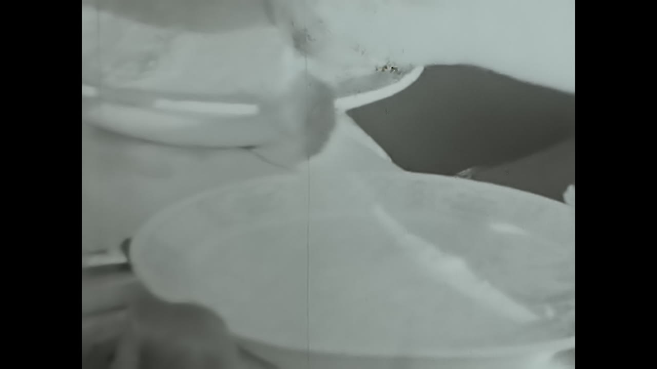 Young Man Spoon-Feeding Himself in a Candid Moment of Everyday Life. CIRCA USSR 1980s: A snapshot capturing a young man engrossed in his meal, eating with a spoon.