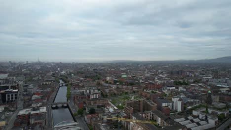aerial panning shot of the city of dublin and liffey river in ireland
