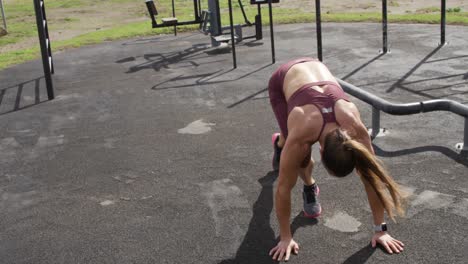 Sporty-Caucasian-woman-exercising-in-an-outdoor-gym-during-daytime