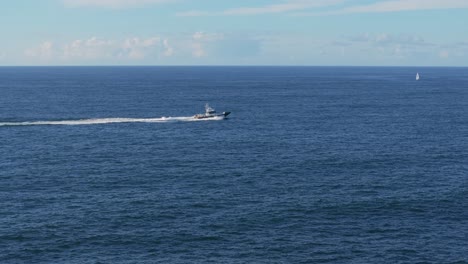 stunning view of boat cruising across the sea at mera beach in galicia, spain. static shot