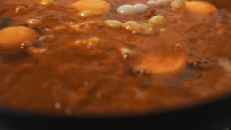 vegetable mix and egg yolks baking inside hot frying pan