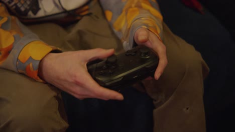 a white teen male playing video games, on a controller