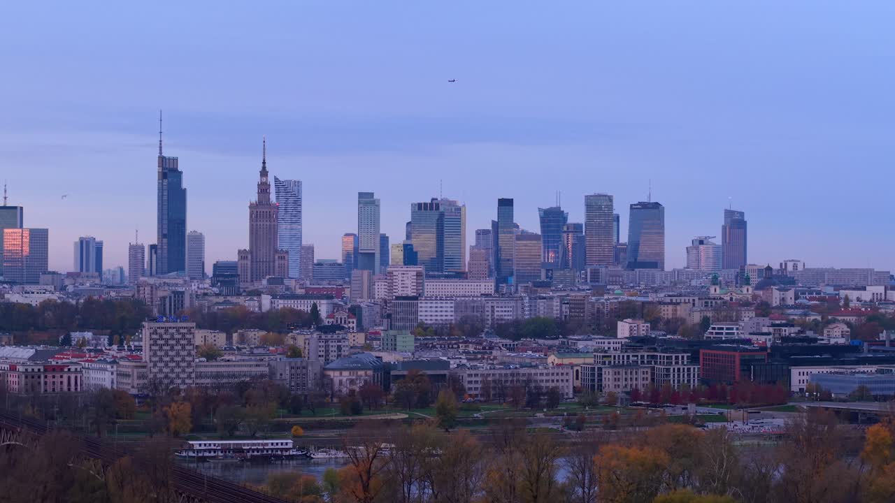 Warsaw, Poland. Drone Shot of Airplane Flying Above Downtown Cityscape Skyline on Autumn Morning