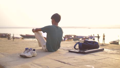 young man drawing by the ganges