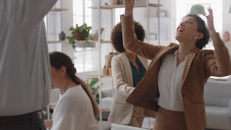 happy-business-people-celebrating-successful-corporate-victory-throwing-papers-in-air-colleagues-embrace-teamwork-in-office-meeting-enjoying-winning-success