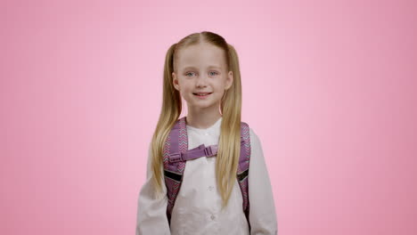 girl with backpack giving ok sign