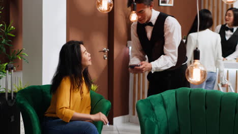 asian client paying for coffee served in lounge area