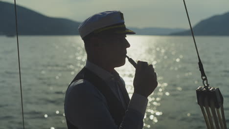 man smoking pipe on boat