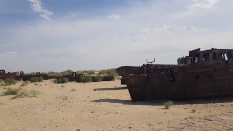 abandoned rusty ships and boats in sand, former aral sea natural catastrophe, central asia