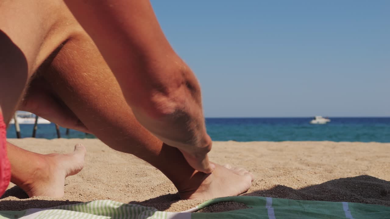 Man Applying Sunscreen on Beach