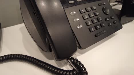 Dialing-the-phone-at-work-to-make-a-call-to-the-company