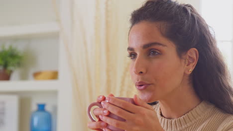 Woman-Relaxing-At-Home-Sitting-At-Table-With-Hot-Drink