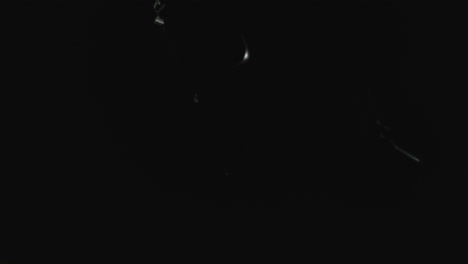 pistols on the dark background and in blinking lights are falling in slowmotion